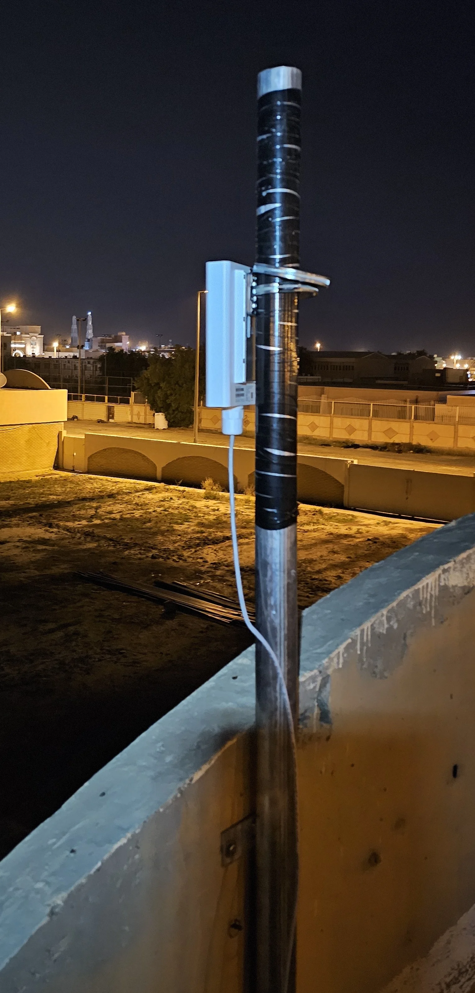 5G outdoor router mounted on a rooftop pole in Kuwait providing high-speed wireless internet connectivity.